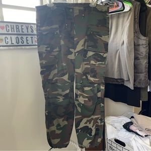 Girls and teen low rise camo pants with drawstring cuffs.